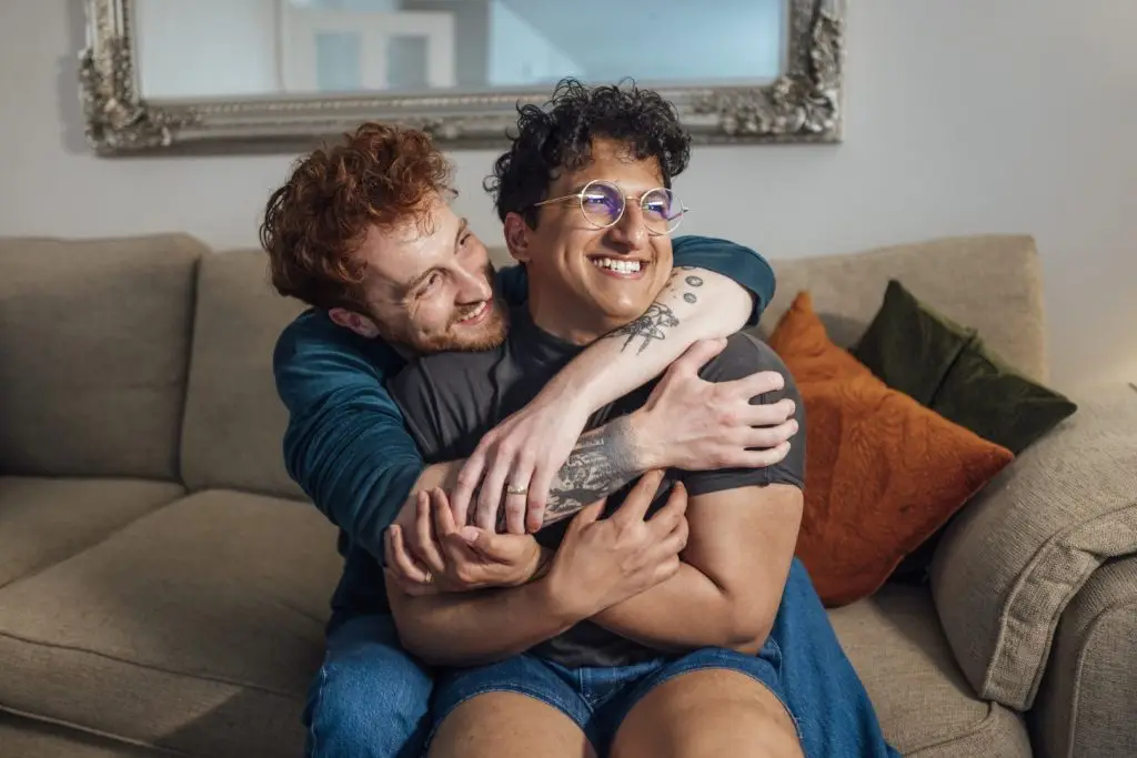 Same Sex Couple Hugging Each Other at Home